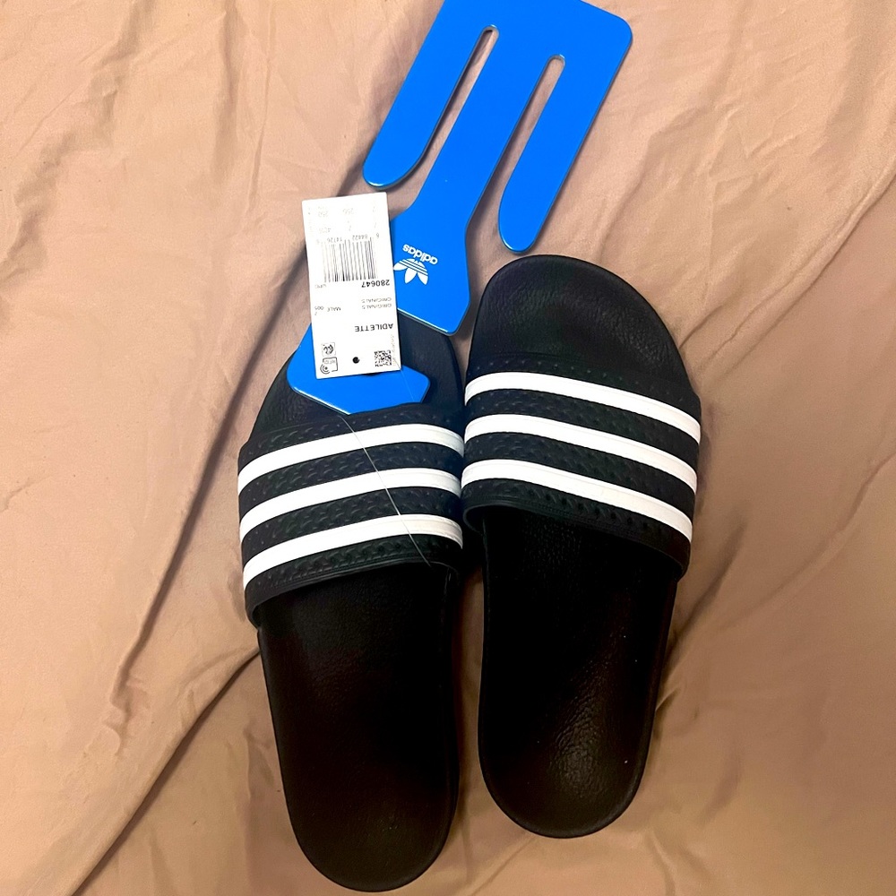 Adidas adilette slides in black. Brand new with tags in Men’s 7/Women’s 8